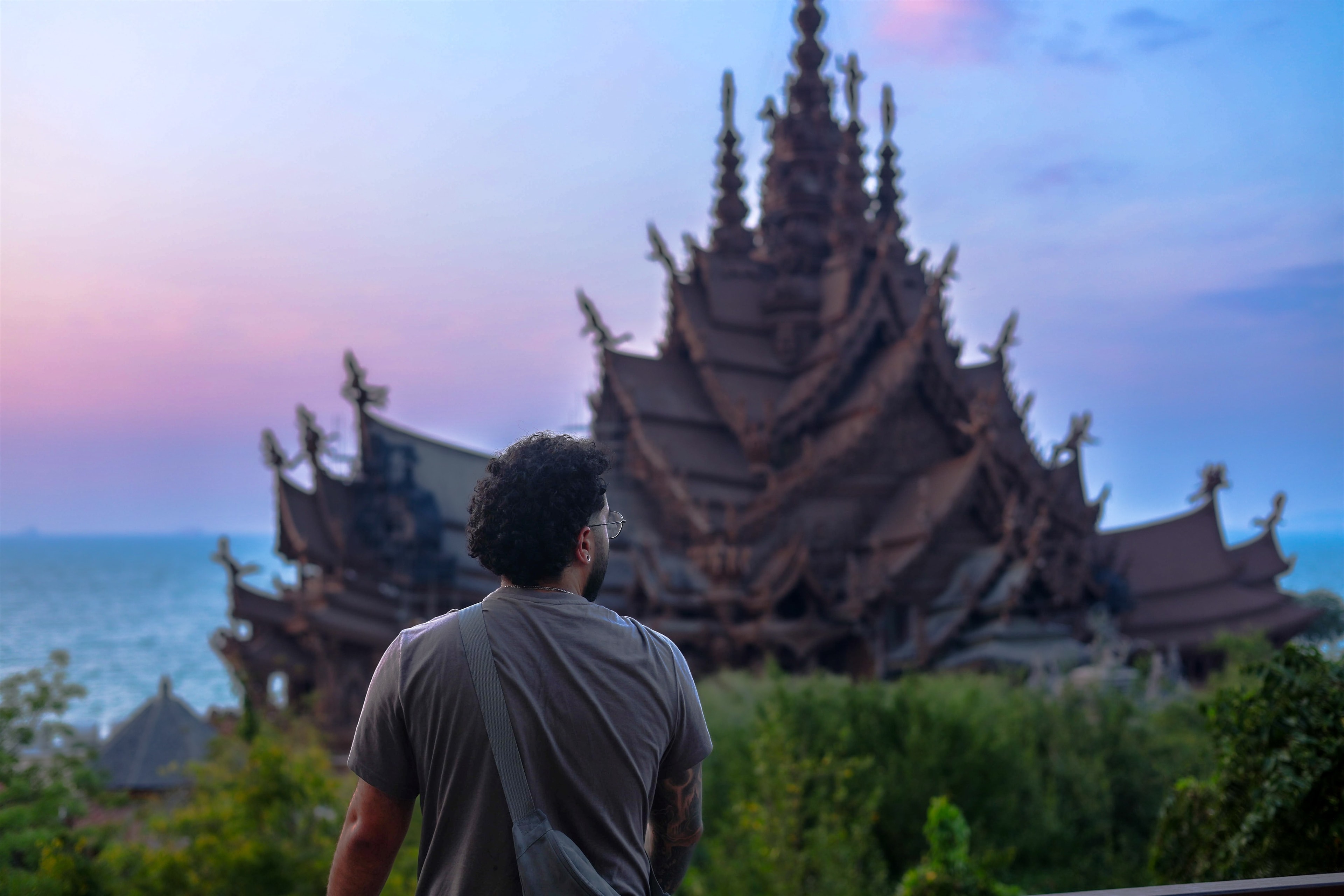 Looking up at the carved spires of the Sanctuary of Truth at dusk, the sea just visible beyond.